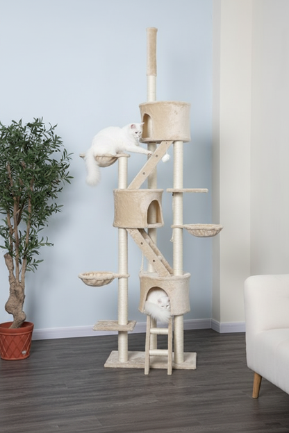 Two white cats playing on beige floor-to-ceiling cat tree in modern living room