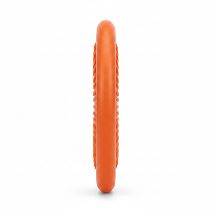 Side profile view of orange rubber dog frisbee showing thickness and soft edge